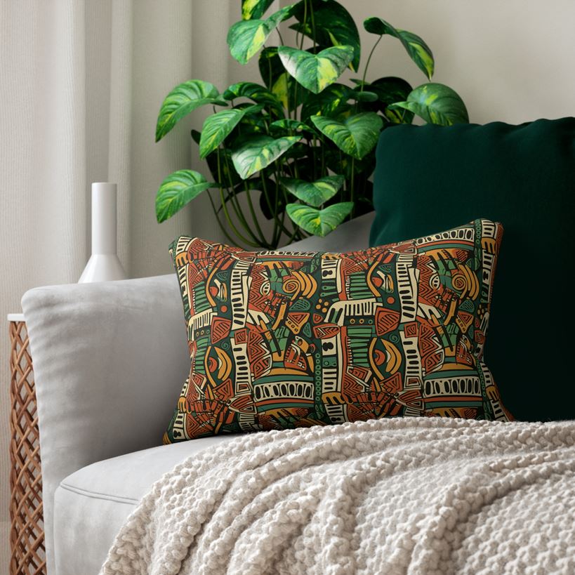 African pattern on couch pillow with plant behind