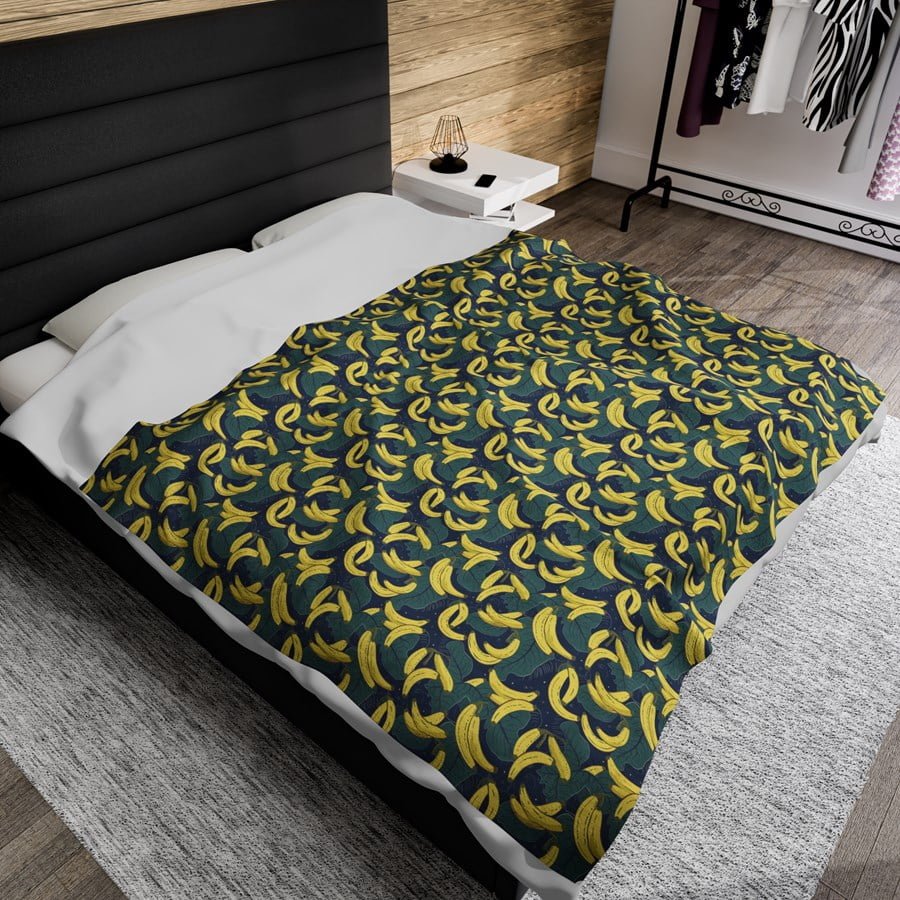 Pattern of bananas on a dark background printed on a blanket