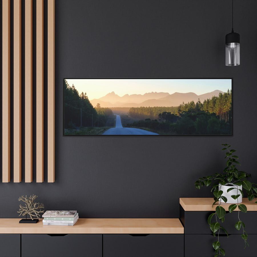 Photo print of a road cutting through the forests with mountains in the distance