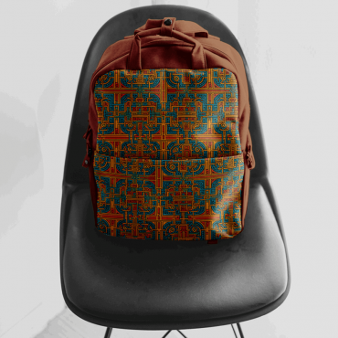 A bright colored weaving maze repeat pattern on a backpack